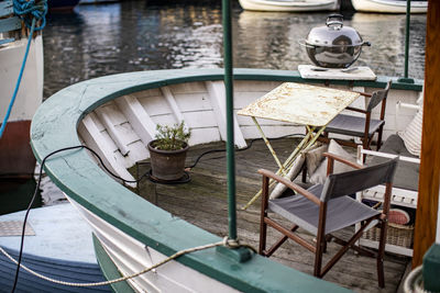 High angle view of chairs and table at lake