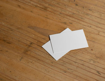 High angle view of paper on wooden table