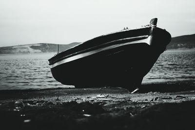 Boat moored at shore against sky