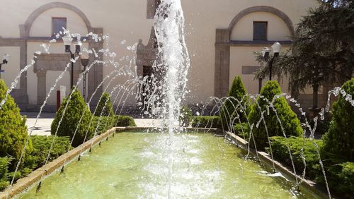 Water fountain against built structure