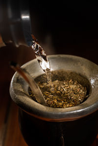 Close-up of pouring coffee in glass container