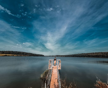 Woman on lake against sky