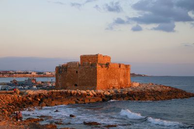 View of fort against sea during sunset