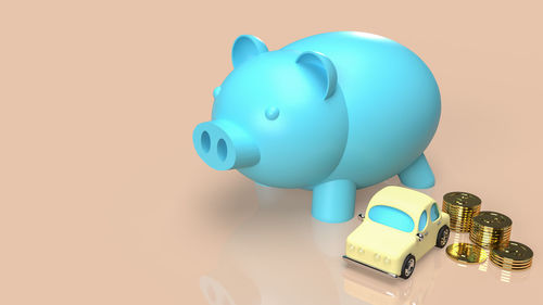 Close-up of piggy bank against pink background