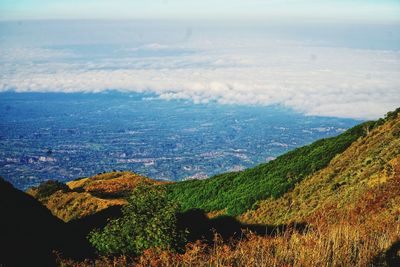 Scenic view of sea and mountains against sky