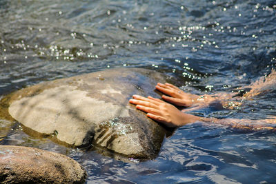 Close up of hands coming out from under water