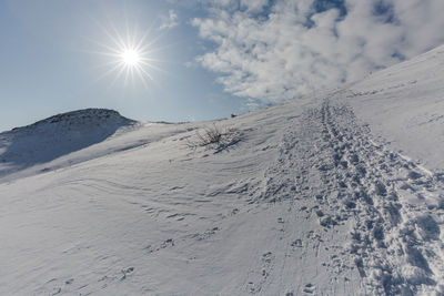 Scenic view of snowcapped mountains against sky