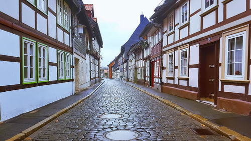 Empty alley amidst buildings in city