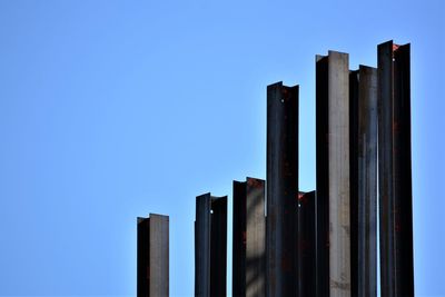 Low angle view of modern building against clear blue sky