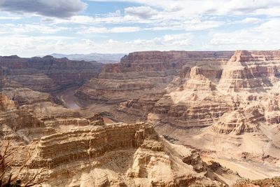 Scenic view of rock formations against cloudy sky