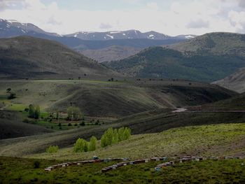 High angle view of field and mountains against sky