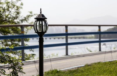 Lighting equipment against railing on bridge