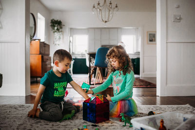 Brother and sister playing with magnetic tiles in living room