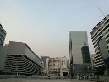 Modern buildings in city against clear sky