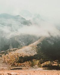 Scenic view of mountains against cloudy sky