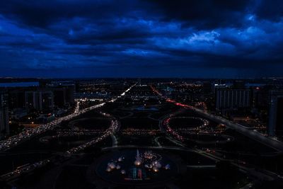 High angle view of city lit up at night