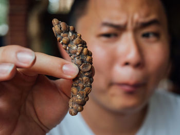 Close-up of man holding food