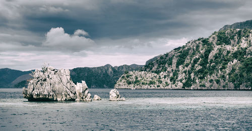 Panoramic view of sea and mountains against sky