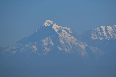 Scenic view of snowcapped mountains against clear blue sky