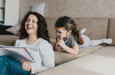 Women sitting on sofa at home