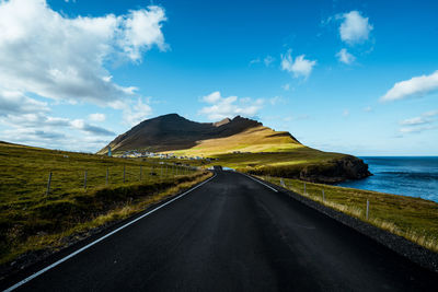 Road by sea against sky