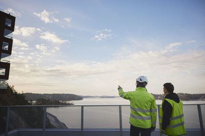 Engineers in reflective clothing talking outdoors