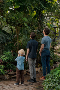 Adventurous family inspecting tropical gallery in botanical garden. local travel