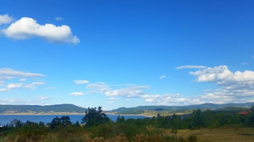 Scenic view of landscape against blue sky