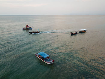 High angle view of boat sailing in sea against sky