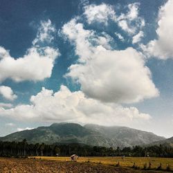 Scenic view of mountains against cloudy sky