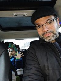 Portrait of man sitting in car