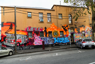 Graffiti on wall by road in city