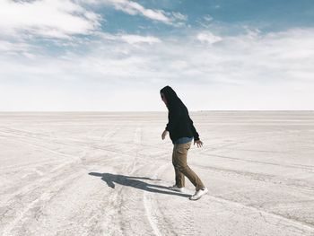 Full length side view of teenager walking at bonneville salt flats