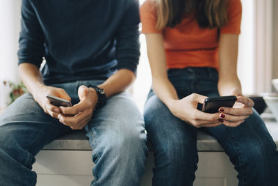 Midsection of woman using mobile phone