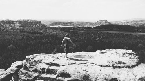 Rear view of woman looking at mountain against sky