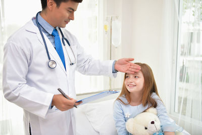 Doctor examining girl in hospital