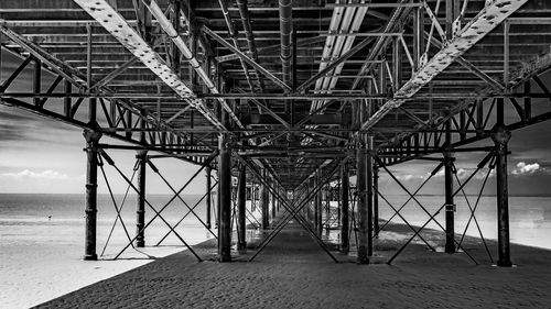 Low angle view of bridge over sea against sky