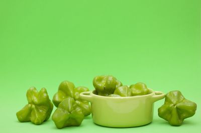 Close-up of vegetables in bowl against green background