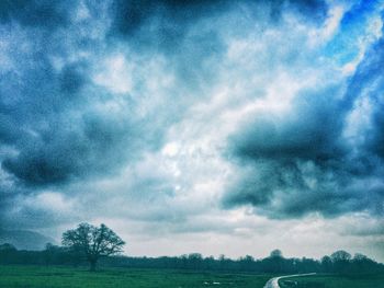 Scenic view of landscape against cloudy sky