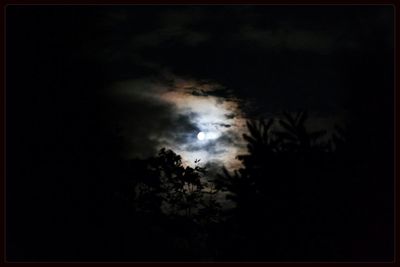 Low angle view of cloudy sky at night