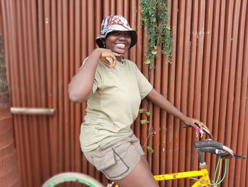 Portrait of smiling man holding bicycle