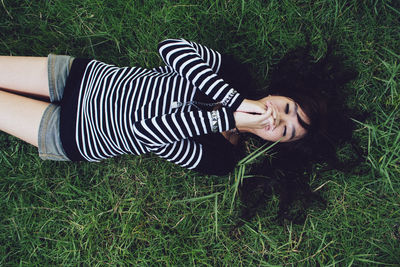 High angle view of woman lying on grass