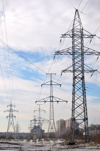 Low angle view of electricity pylon against sky