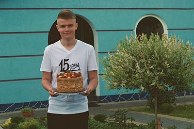 Full length of smiling boy holding ice cream