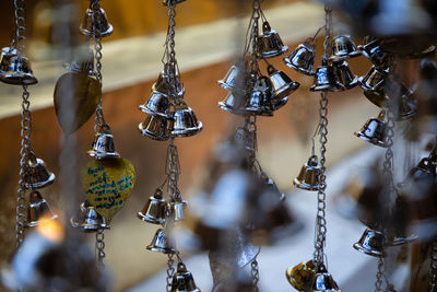 Close-up of decorations hanging in store for sale