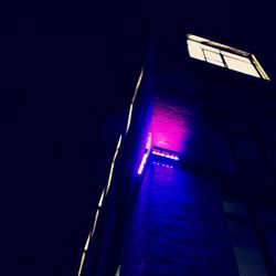 Low angle view of illuminated building at night