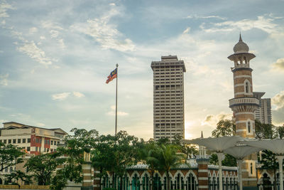 Low angle view of buildings against cloudy sky