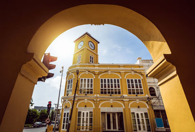 Low angle view of yellow building against sky