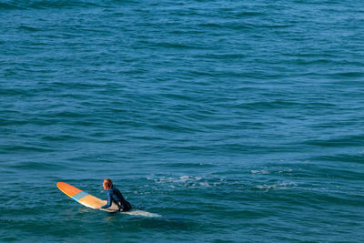 Rear view of man in sea