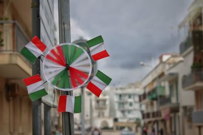 Italian flag pinwheel toy on pole in city